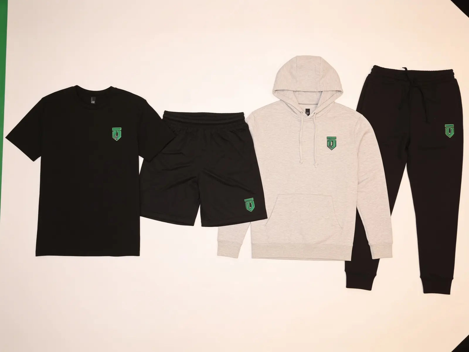 Podium Hoodie Package Preferred level: performance tee, training shorts, hoodie, and joggers with sample green team decoration